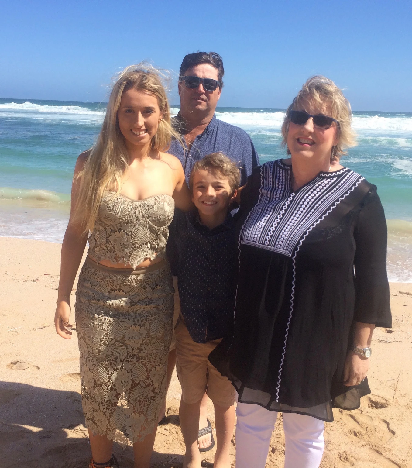 Tash Hammond posing with her family in the beach