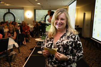 Mid Aged Lady holding a paper in her hand and gets clickes