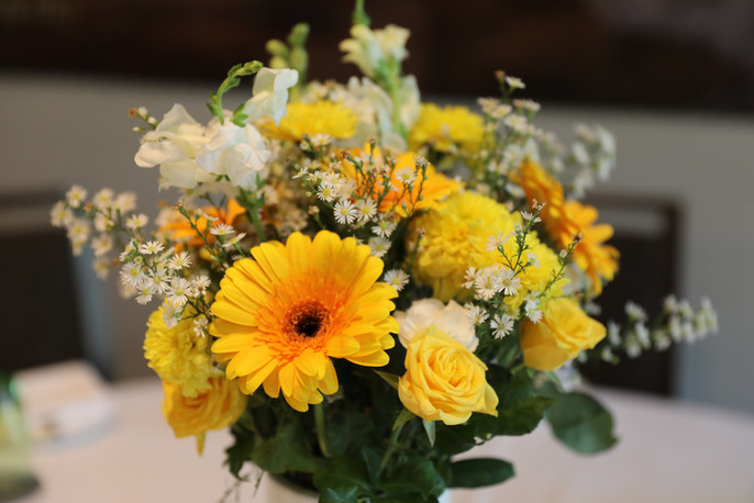 Vase full of Yellow and White Flowers
