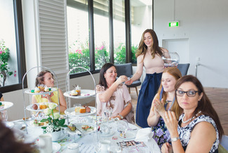High Tea Event a girl serving snacks for the people seated