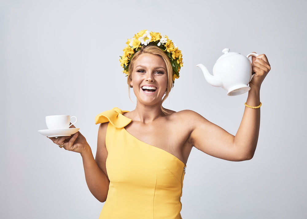 Endometriosis Australia high tea model in yellow holding tea set
