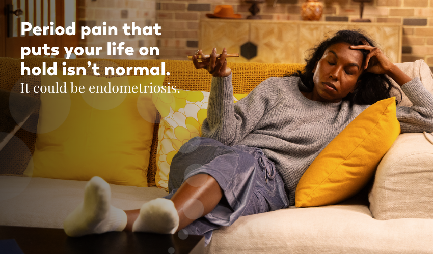 Woman lying on a couch looking thoughtful, representing the long wait for endometriosis diagnosis and the need for timely action.