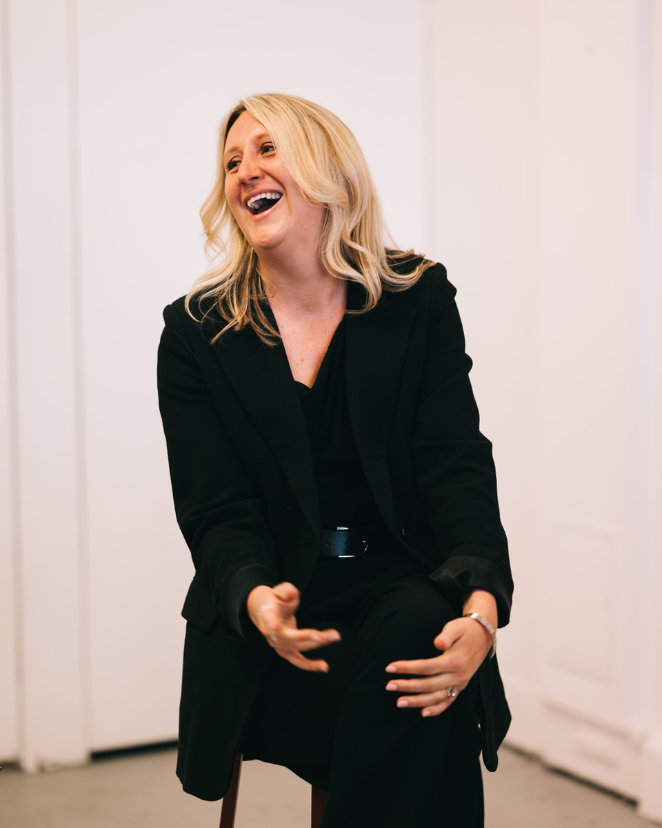 Kate Nixon, Endometriosis Australia ambassador, laughing in black business attire during professional portrait